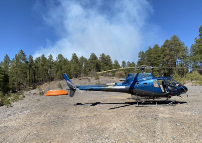 Blue helicopter on top of the mountains