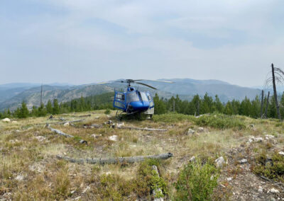 Blue helicopter on top of the mountains