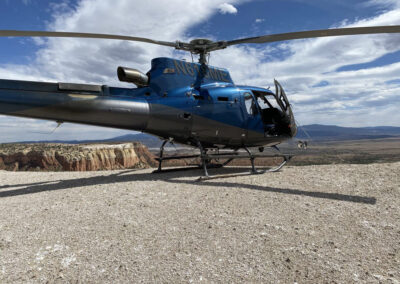 Blue helicopter on top of the mountains