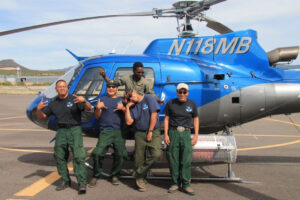 Crew posing outside of the helicopter