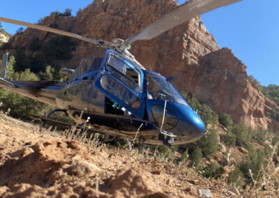 Blue helicopter on top of the mountains