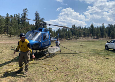 Crew hooking up lines to the helicopter