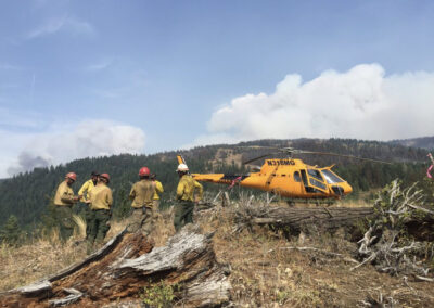 Crew outside of the helicopter in the forest