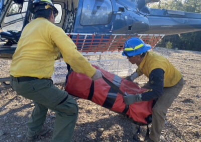 Men hauling bag into the helicopter