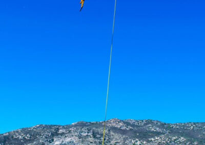 Helicopter in the sky hauling two people