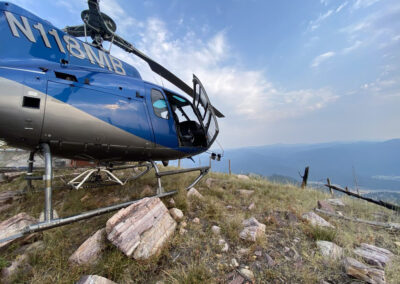 Blue helicopter overlooking mountains