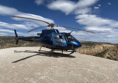 Blue helicopter on top of the mountains