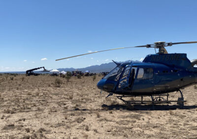 Helicopter in the desert with film crew in the background